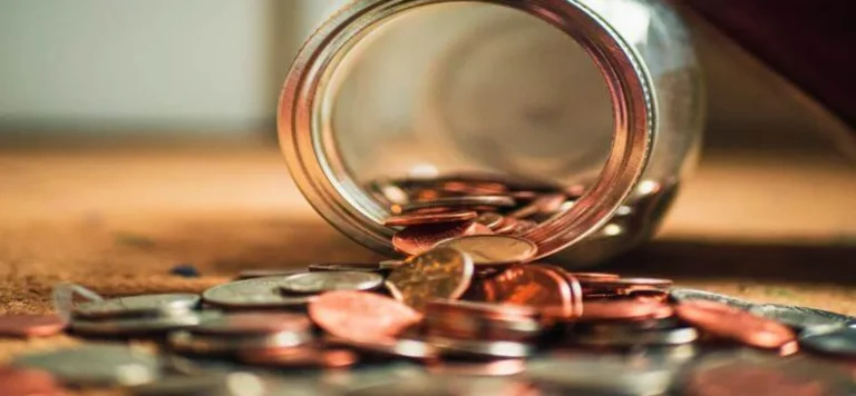 Pote de vidro caído com moedas: É possível registrar uma marca gratuitamente?